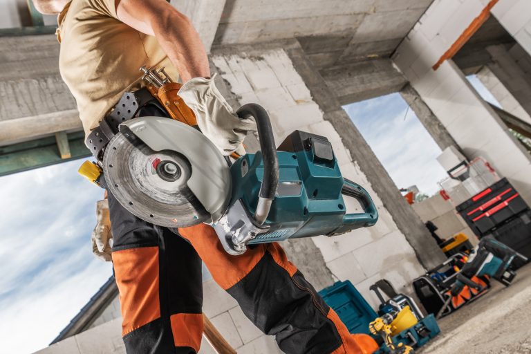 A man walking with a circular saw